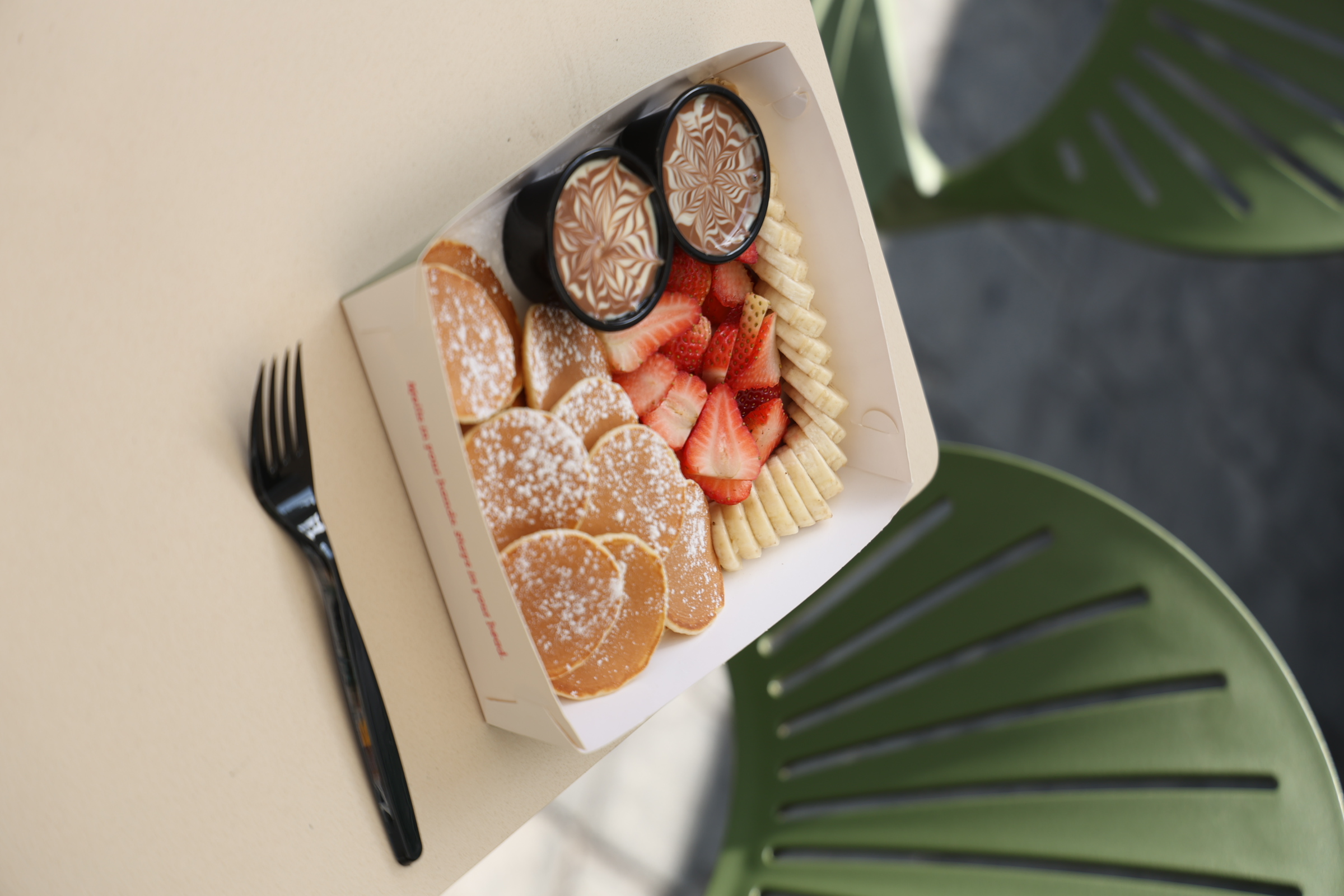 Image of Mini Pancakes – 15 mini pancakes, strawberry, banana. Belgium Chocolate dip, and your choice of lotus, white, or pistachio dip 