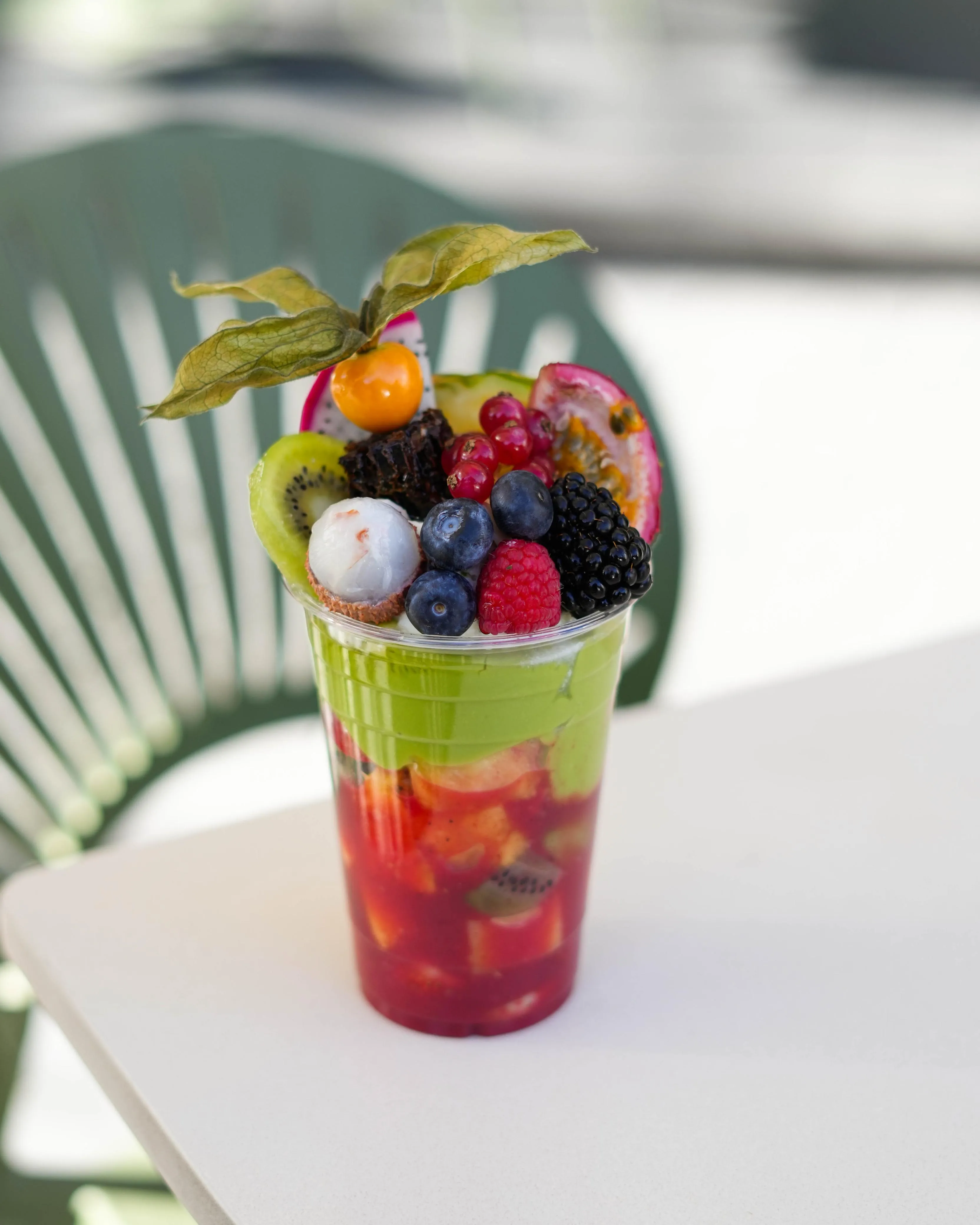 Image of Cocktail Olympic – Sliced fruits, cocktail juice, blended pure avocado, topped with fruits, almonds, and your choice of Ashta or fresh cream