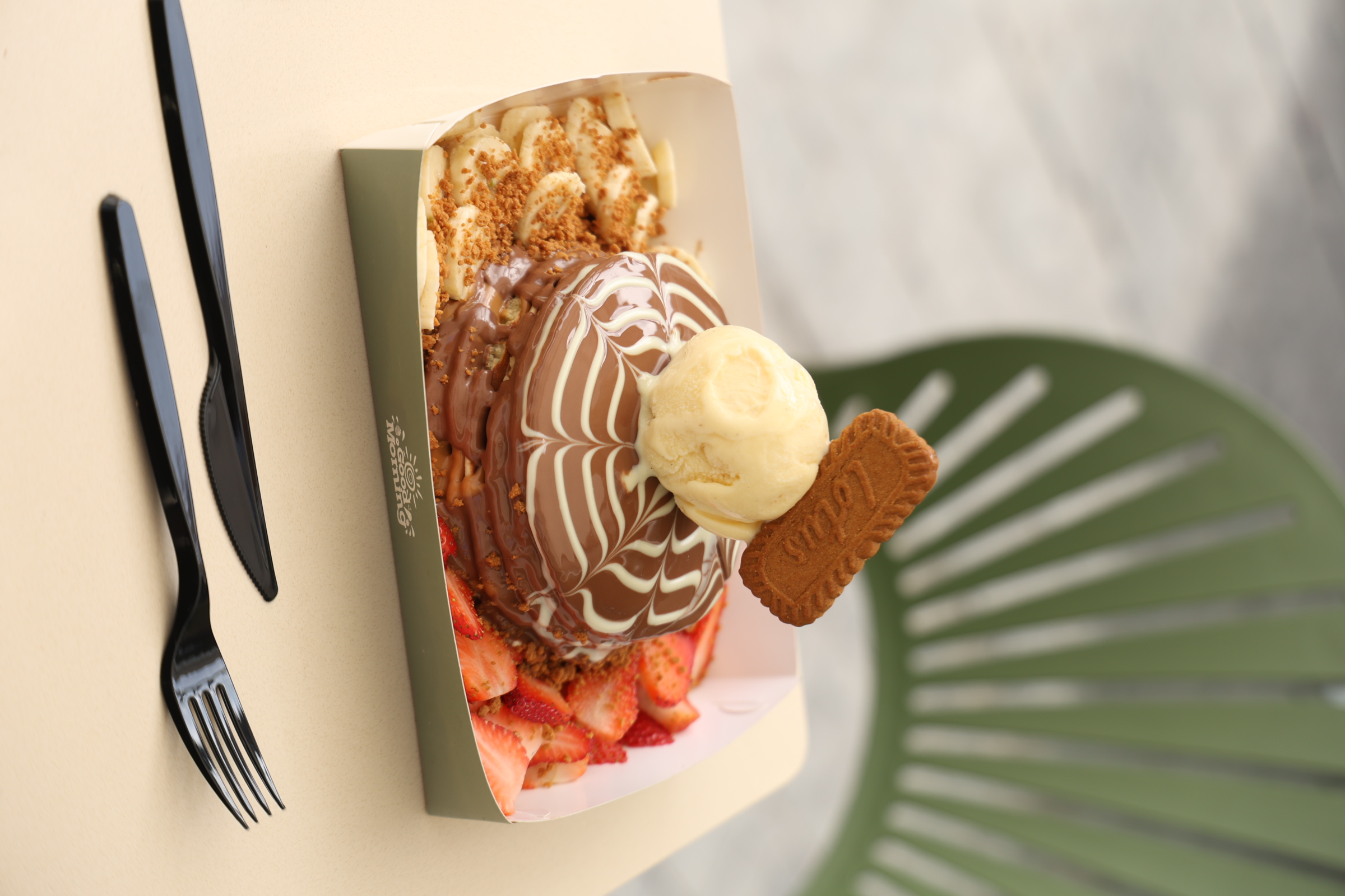 Image of Champion Pancake  – 5 pancake layers, lotus spread between, topped with Ice cream scoop & Belgium Chocolate, served with banana & strawberry slices