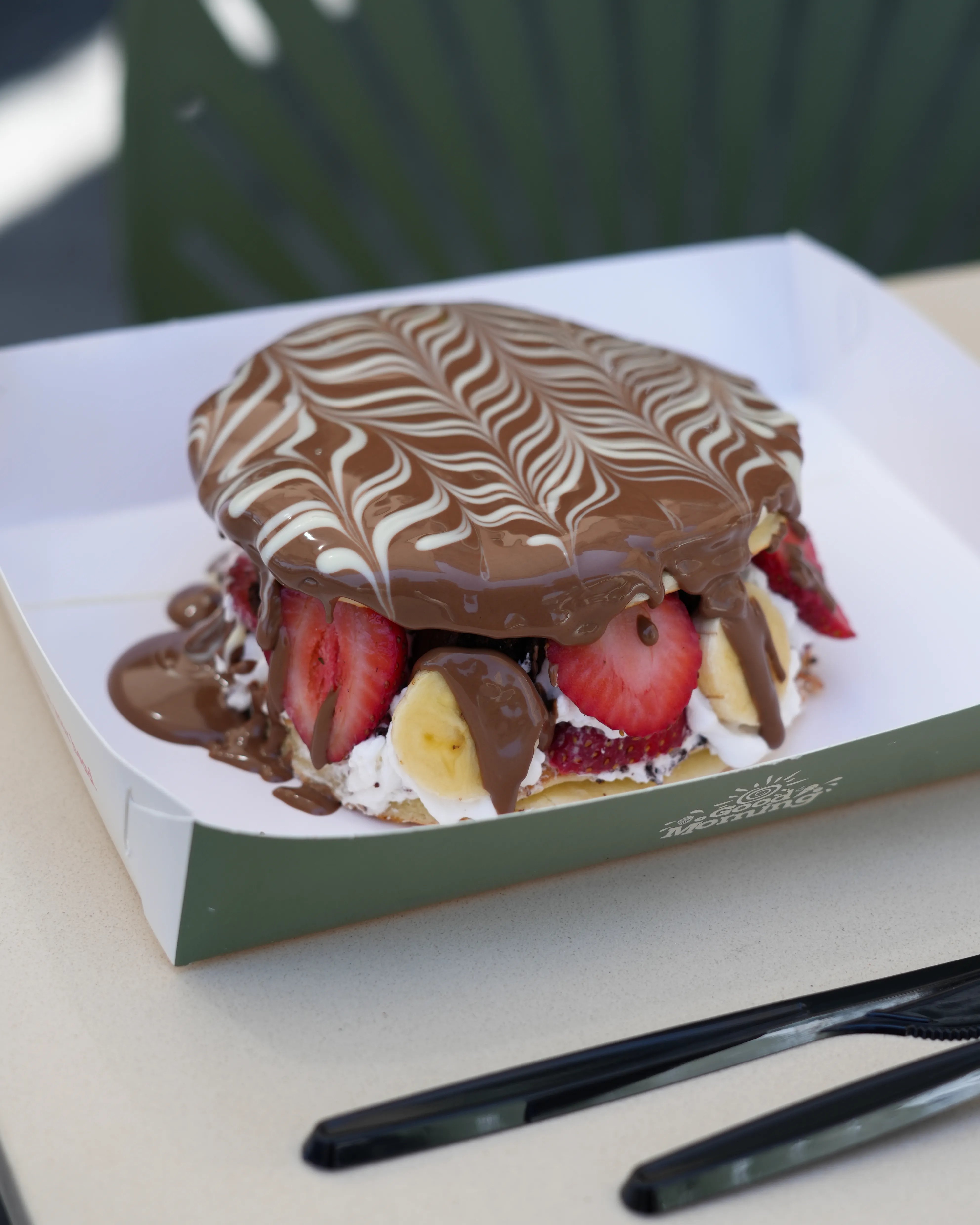 Image of Chocolate Burger – 2 pancake layers, cream cheese, brownies, strawberry & banana all in between, premium belgian chocolate